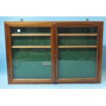 A glazed wall-mounted display case, 60.5 x 92 x 5cm.