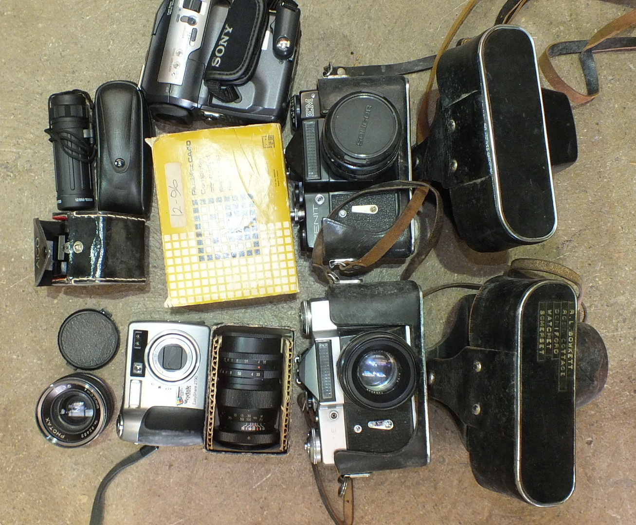 A Zenit EM and a Zenit E camera and other photographic accessories.