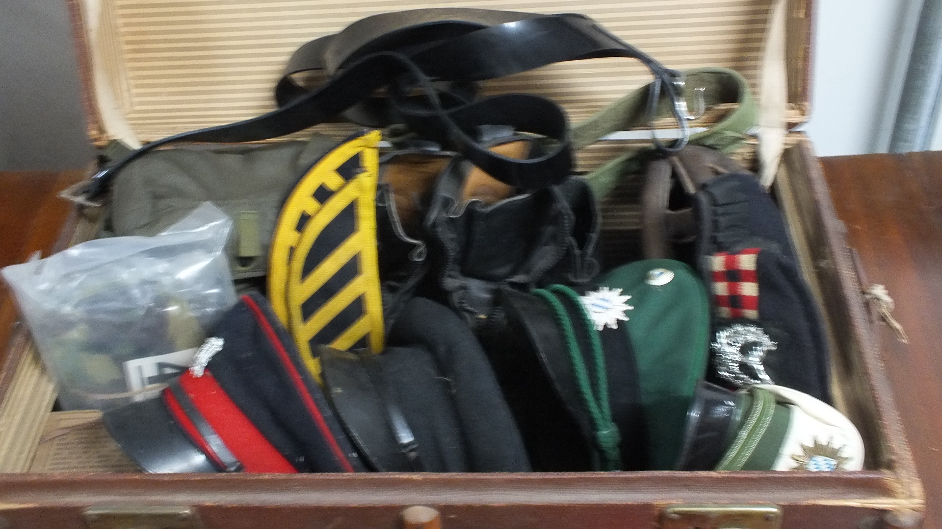 A quantity of mainly British Army items including a 1939 helmet, two pairs of boots, two gas