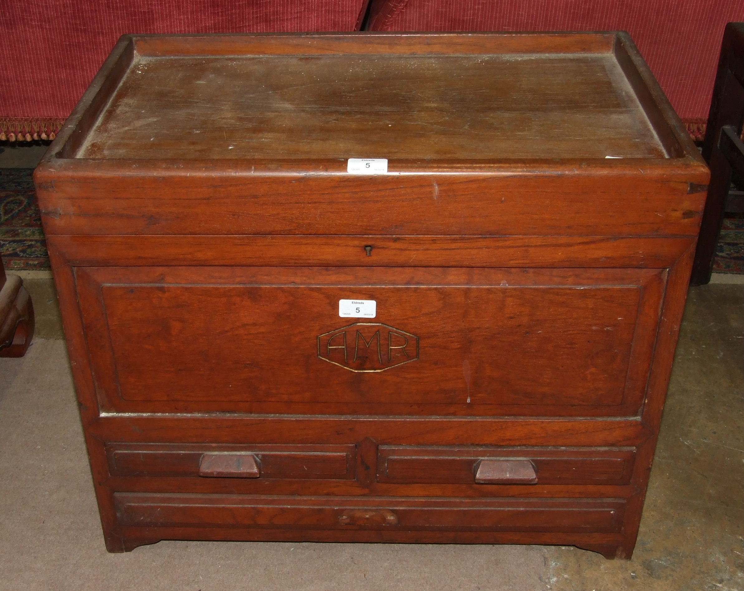 A small hardwood chest, the rectangular hinged lid above two small and one long drawers, 65cm