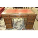 An Edwardian stained wood knee-hole desk, the rectangular top with writing inset above three