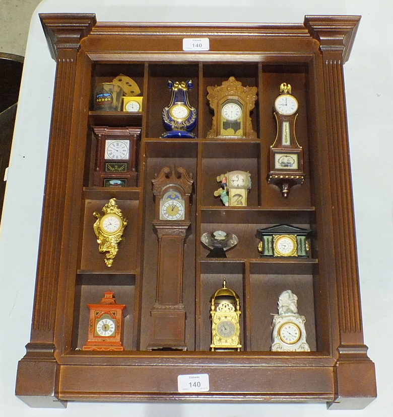 A Franklin Mint collection of miniature clocks, in rack.