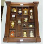 A Franklin Mint collection of miniature clocks, in rack.