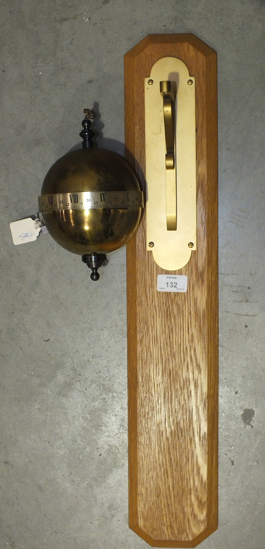 A modern gravity globe clock with horizontal silvered chapter ring and pointer, 23cm, suspended on a