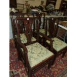 A set of six 20th century hardwood Chippendale style dining chairs, each with pierced centre