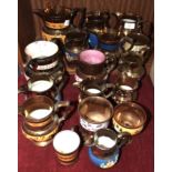 A collection of thirteen mainly copper lustre ceramic jugs, 18cm - 9cm and other lustre ware.