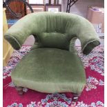 A late 19th century upholstered tub armchair with turned front legs.