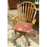 A reproduction oak slat-back swivel office chair and an oak occasional table, (2).