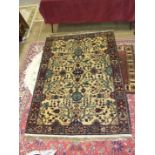 A modern Oriental rug with geometric design on ivory and burgundy field, 220 x 140cm.