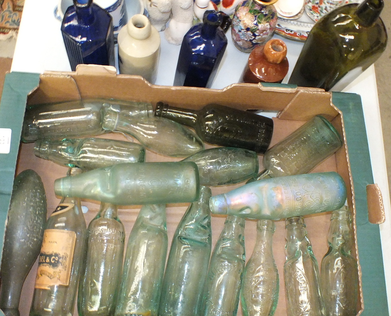 A collection of 19th century lemonade and beer bottles, two blue hexagonal poison bottles and two