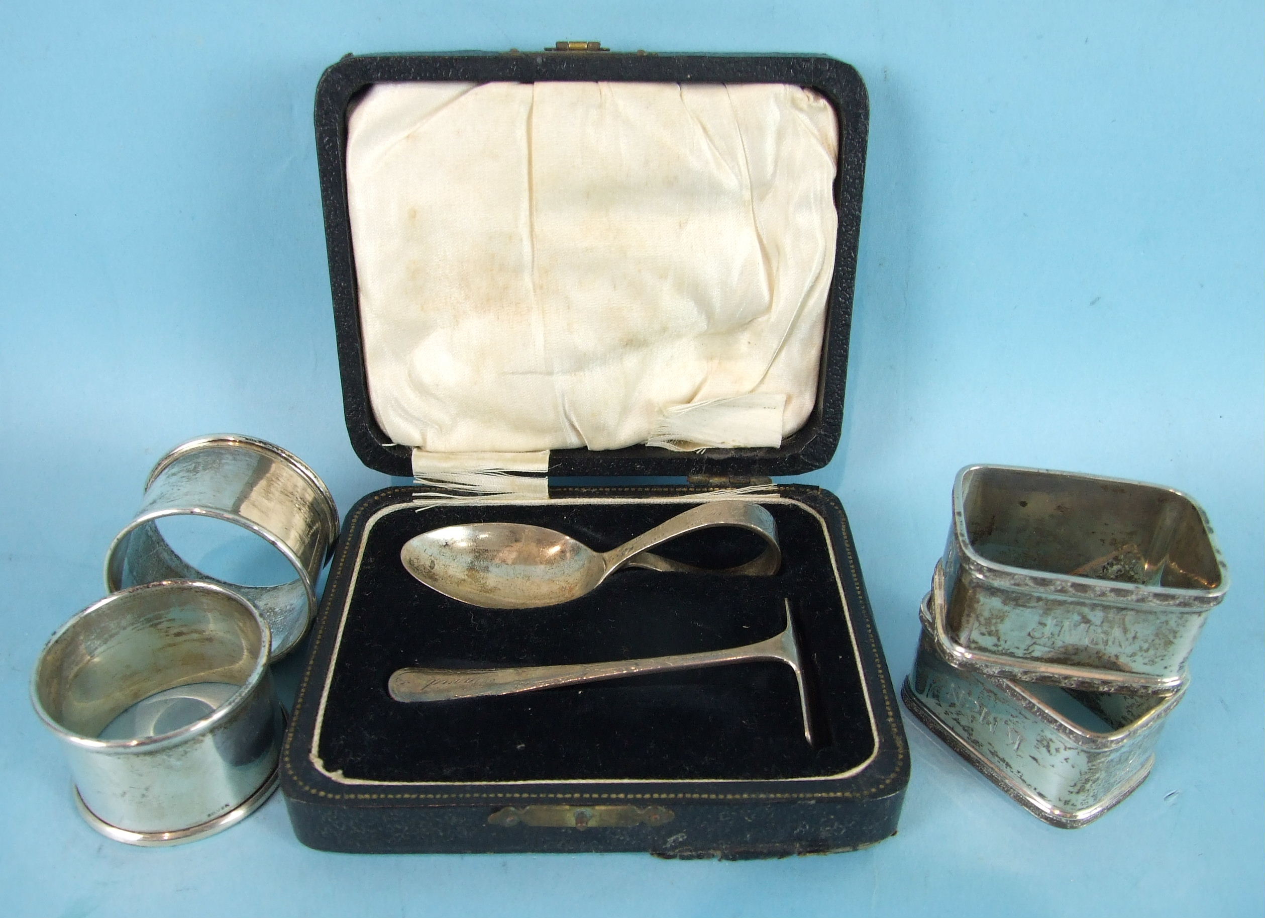 A baby's silver spoon and pusher, Sheffield 1929, cased, a pair of modern rectangular napkin