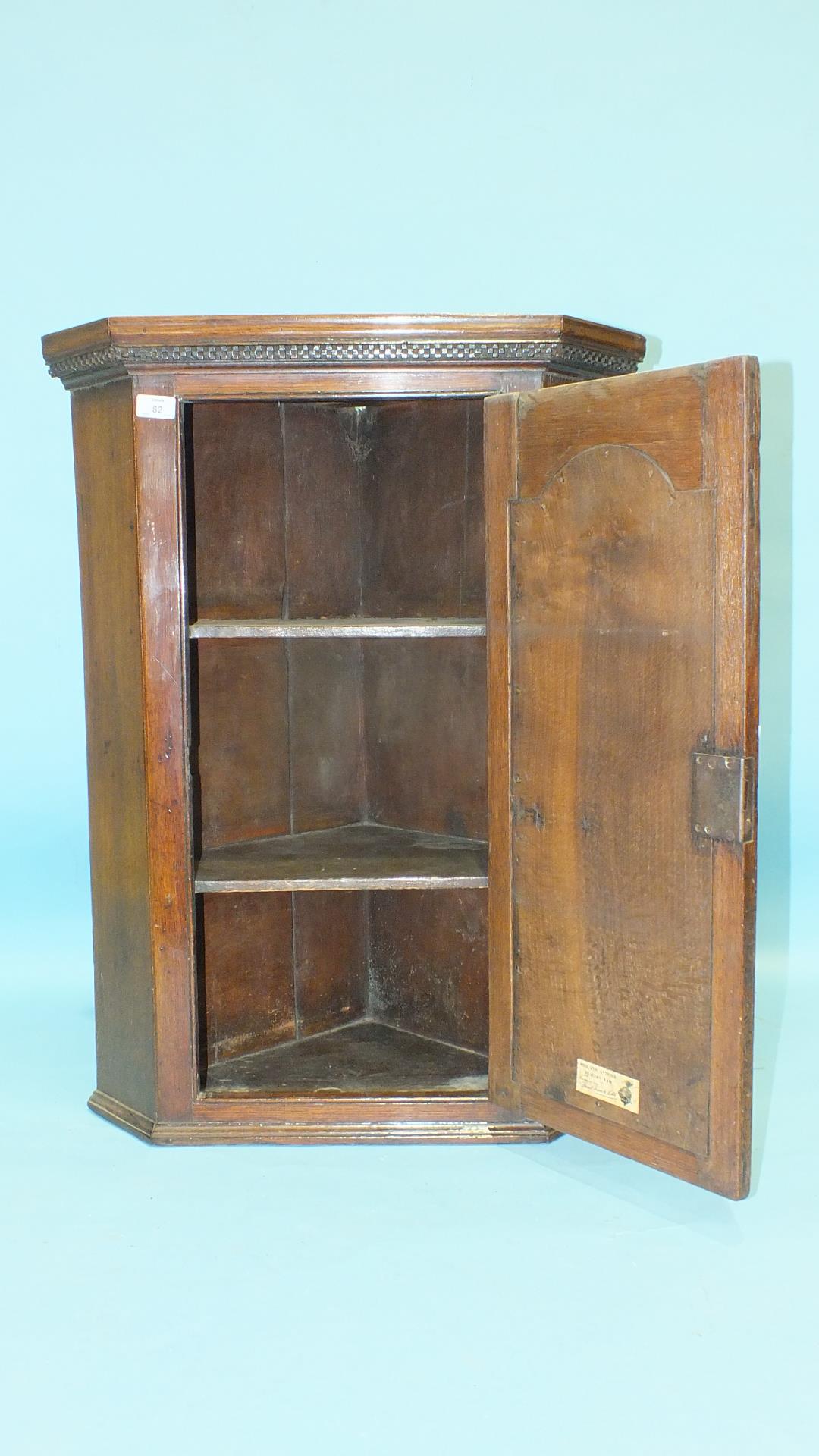 A small Georgian oak hanging corner cupboard, the panelled door with inlaid star motif, 63cm wide, - Image 2 of 3