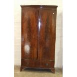 A Georgian-style mahogany bow-fronted two-door wardrobe, with dentil cornice and base drawer,