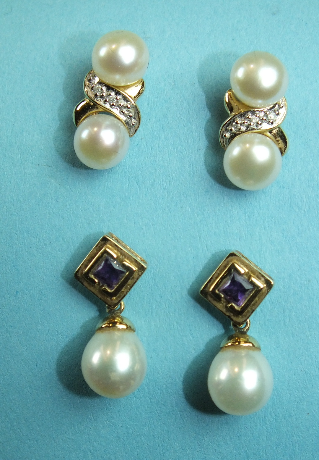 A pair of amethyst and cultured pearl drop earrings and another pair each set two cultured pearls.