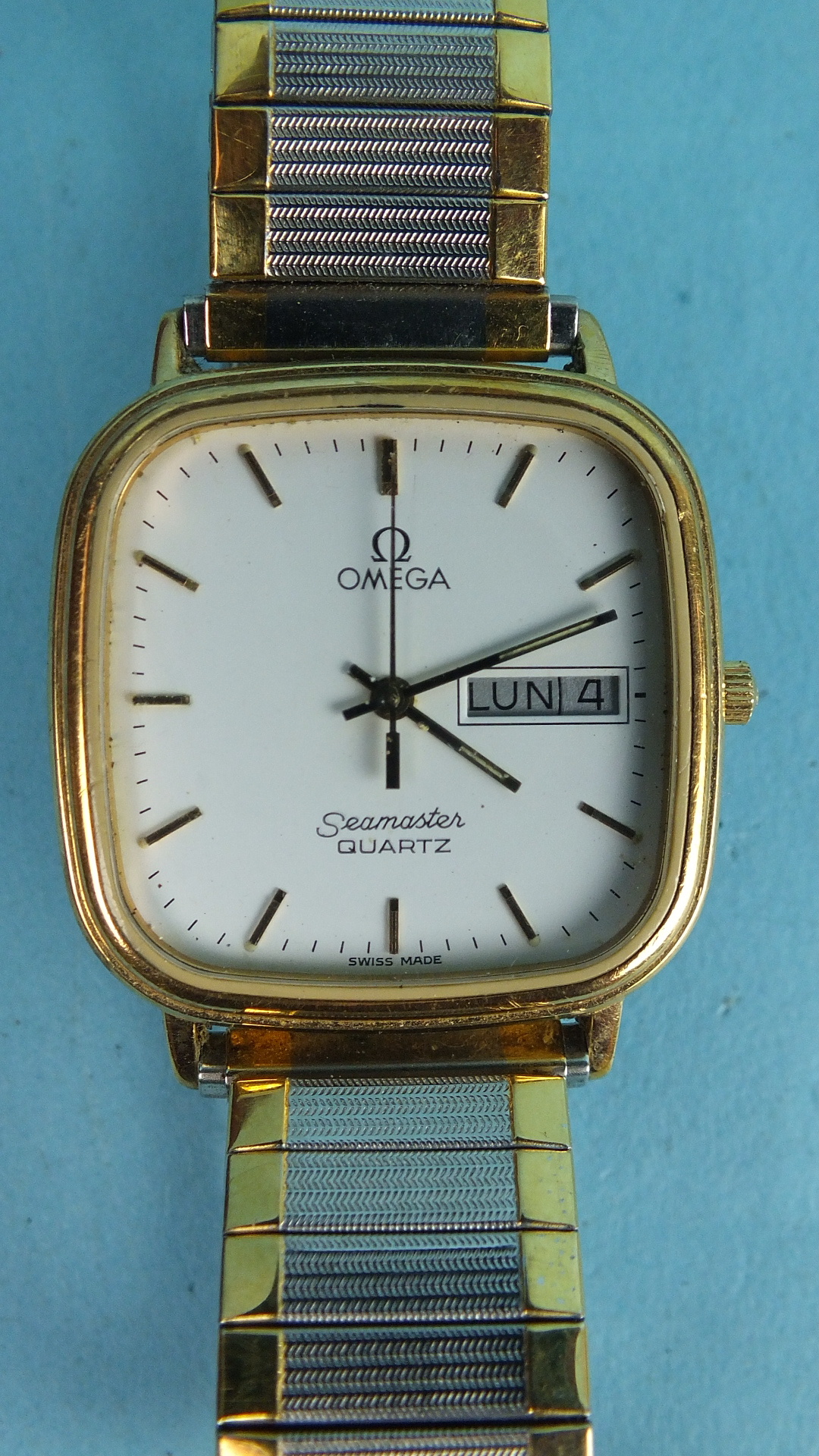 Omega, a gentleman's Omega Seamaster quartz wrist watch with gold-plated rounded-square face,