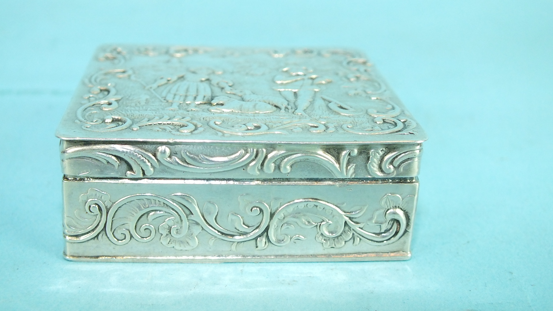 A small Continental silver square box, the lid embossed with a shepherdess and musician within - Image 2 of 2