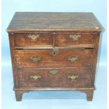 A reconstructed antique oak chest of rectangular form, having two short and two long drawers, on