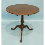 An 18th century mahogany tripod table, the circular top with moulded border, on carved and turned