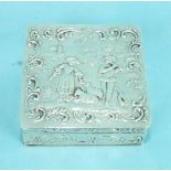 A small Continental silver square box, the lid embossed with a shepherdess and musician within