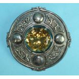 A large silver Celtic plaid brooch claw-set a citrine within border of knot-work panels and
