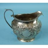 An embossed cream jug of bulbous oval shape, with gadrooned rim, 8cm high, Birmingham 1900, ___3½