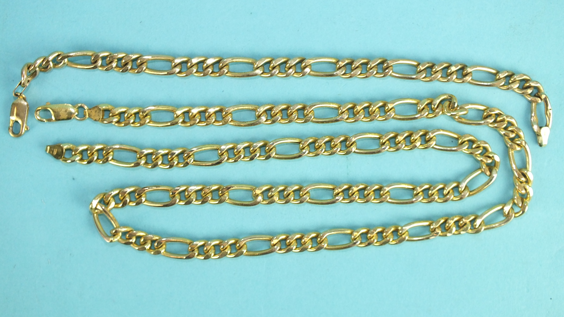 A 9ct yellow gold necklace and matching bracelet of fancy curb links, 61cm and 20cm long, 31.6g.