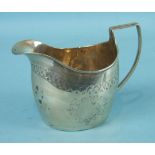 A late-George-III large cream jug with bright-cut decoration and reeded handle, marks rubbed,