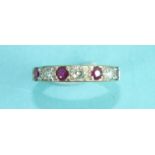 A ruby and diamond half-eternity ring alternately-set four round-cut rubies and three brilliant-