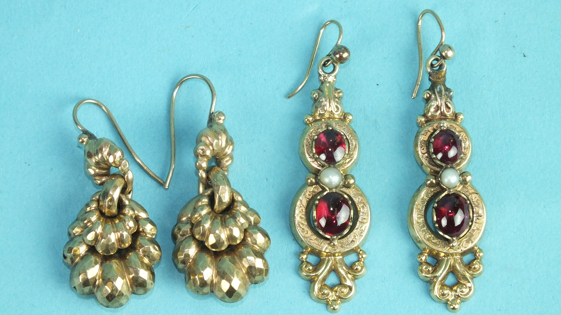 A pair of Victorian pendant earrings each set two foiled cabochon garnets and a pearl, (one