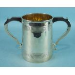 A late-Victorian two-handled trophy of plain tapered form with bands of reeding and two scrolling