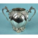 A Victorian two-handled trophy bowl, the ovoid embossed panel body with intermediate masks raised on