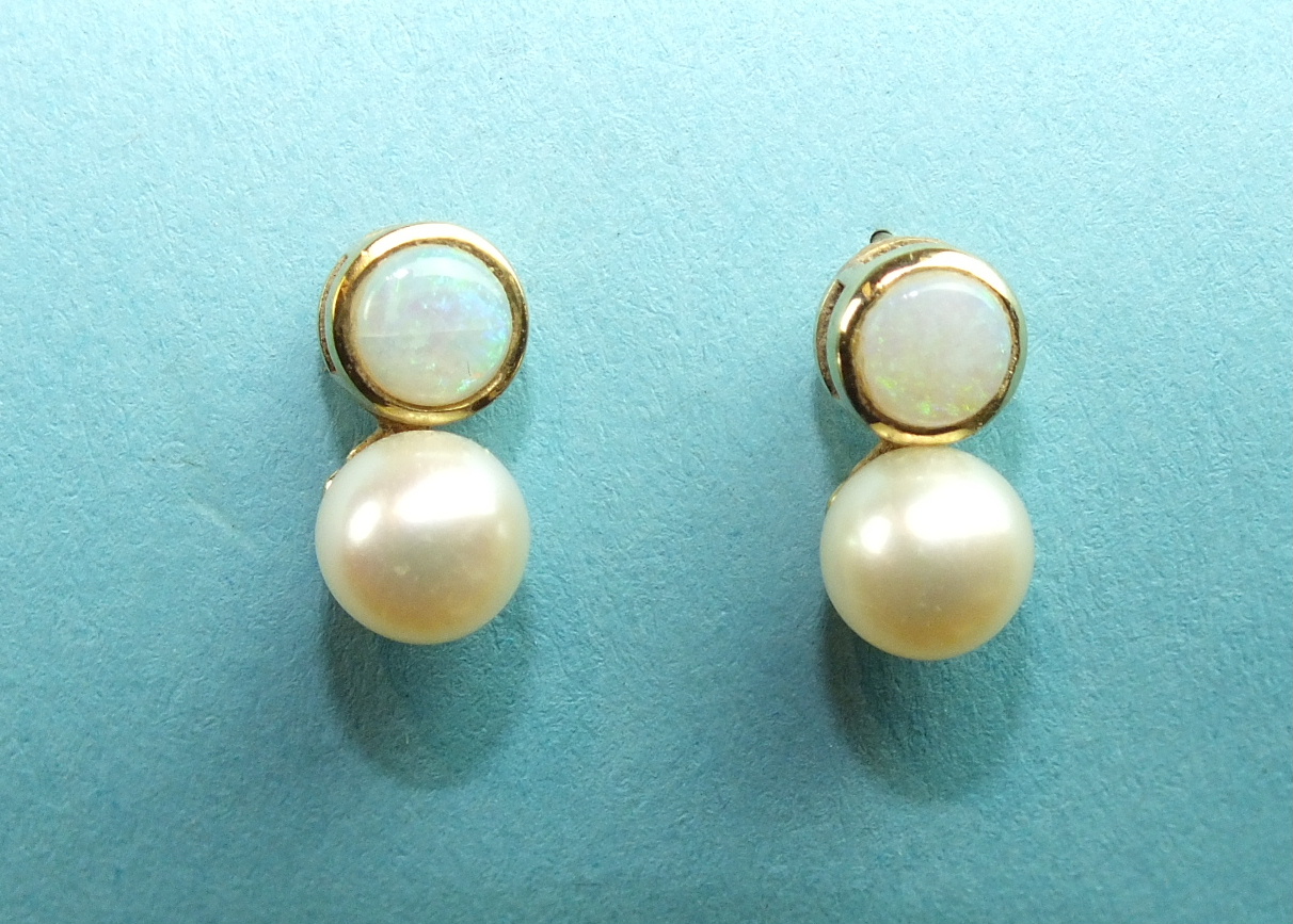 A pair of opal and pearl earrings, each collet-set a round opal with cultured pearl below, on 9ct