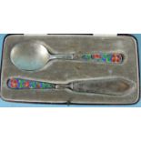 Bernard Instone, a cased Christening set consisting of a spoon and knife, the handles with red,