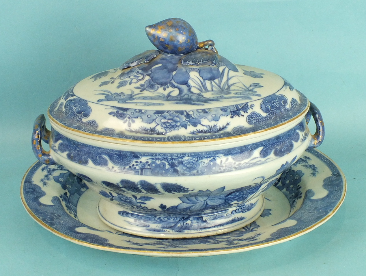 An early-19th century Chinese Export oval tureen, cover and stand painted with water plants below