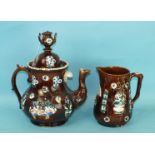 A 19th century Measham Pottery bargeware baluster-shaped teapot with treacle glazes and floral
