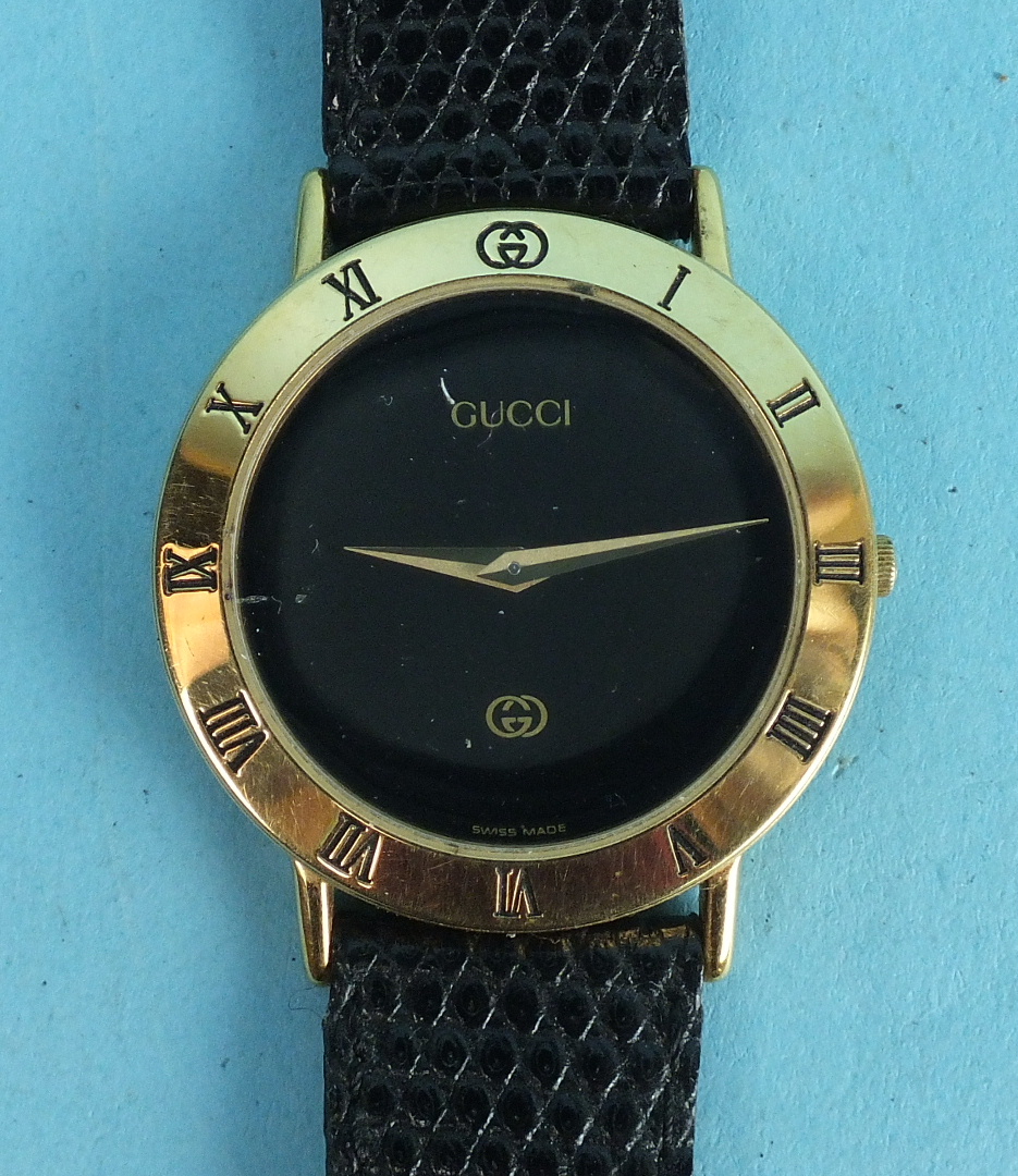 Gucci, a gents quartz wrist watch, the circular black face with Roman numerals on bezel, original