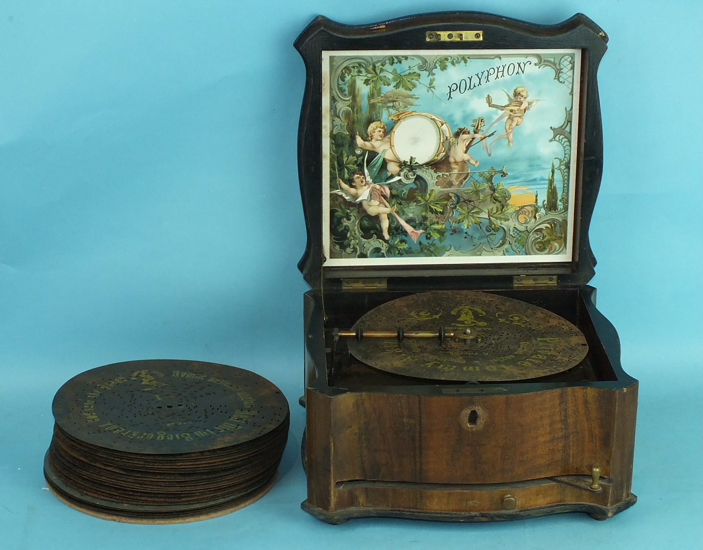 A Victorian walnut Polyphon music box playing 8¼" discs, single comb in good order, 38cm wide,