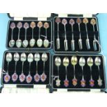 Two sets of enamel and silver teaspoons and a set of cake forks, prizes for Kent County Water Polo