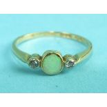 An 18ct yellow gold ring collet-set an opal between two brilliant-cut diamonds, size M½, 2g.