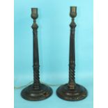 A pair of turned mahogany lamp stands in the Georgian taste, each with fluted column and brass