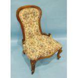 A late-Victorian walnut nursing chair on carved cabriole legs, similar to lot 72.