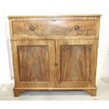 An early-19th century mahogany secretaire writing chest, the fitted drawer above a pair of