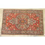 An Oriental rug with central medallion, on red ground and foliate borders, 224 x 136cm.