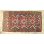 A mid-20th century Persian rug, the central ground with six octagonal medallions within a multiple