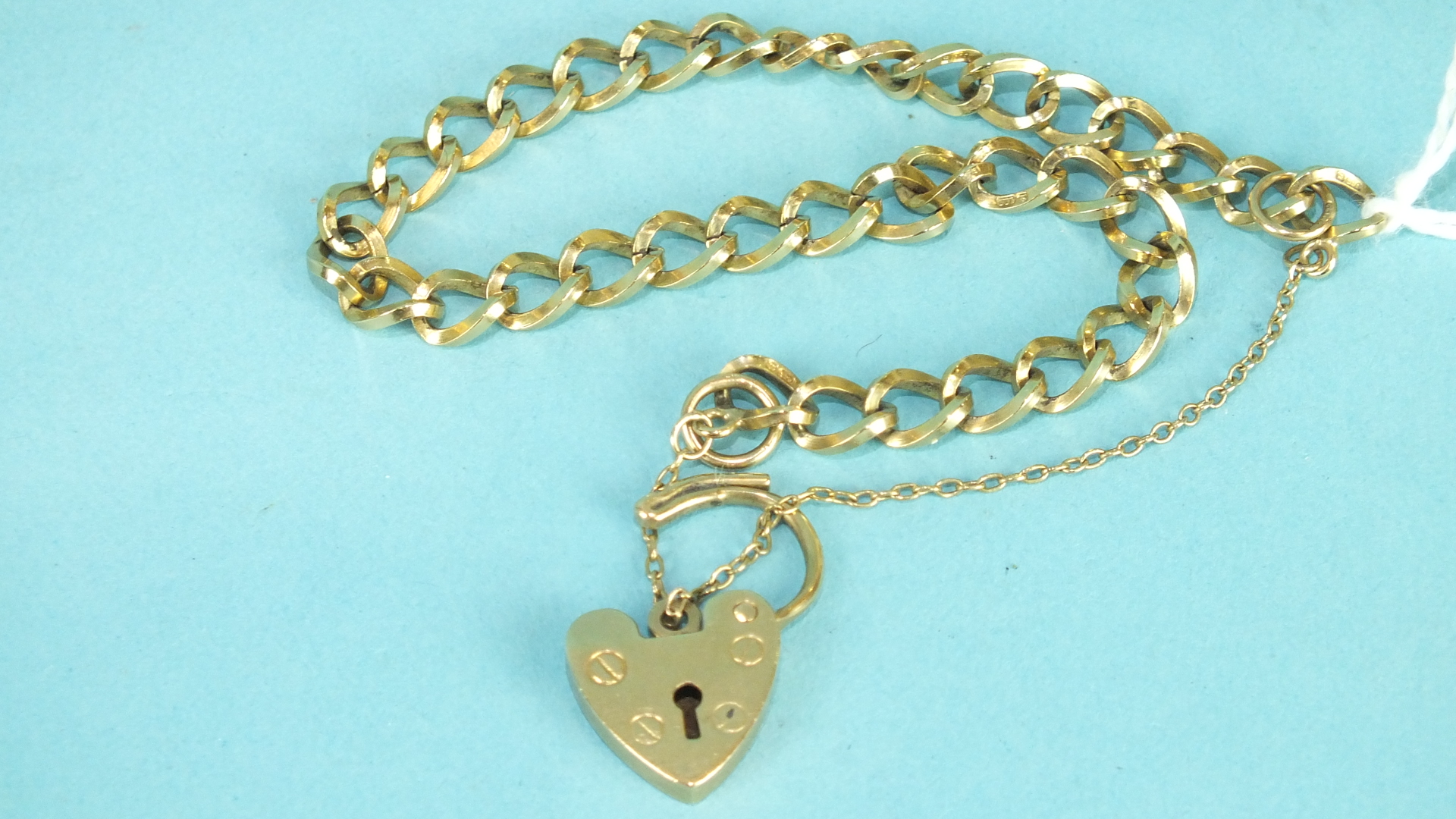 A 9ct gold curb-link bracelet with padlock clasp, 8.8g.