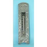 An early-20th century Chinese thermometer within a white metal frame embossed with dragons, 23cm