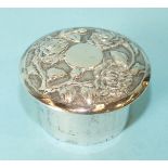 A small Chinese silver pill box of cylinder form, with embossed screw top, maker HC, 4.5cm diameter.