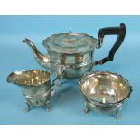 A three-piece silver tea service of plain form with serrated borders, Sheffield 1918 and 1920, maker