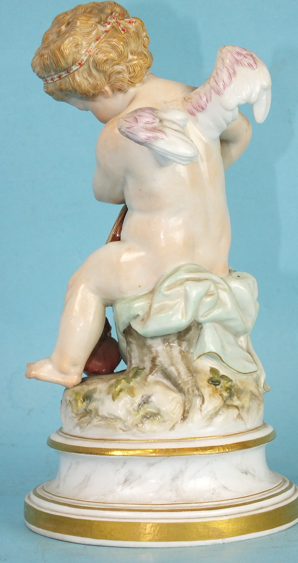 A 19th century Meissen porcelain figure of a winged cherub lighting the flaming heart with his - Image 3 of 4