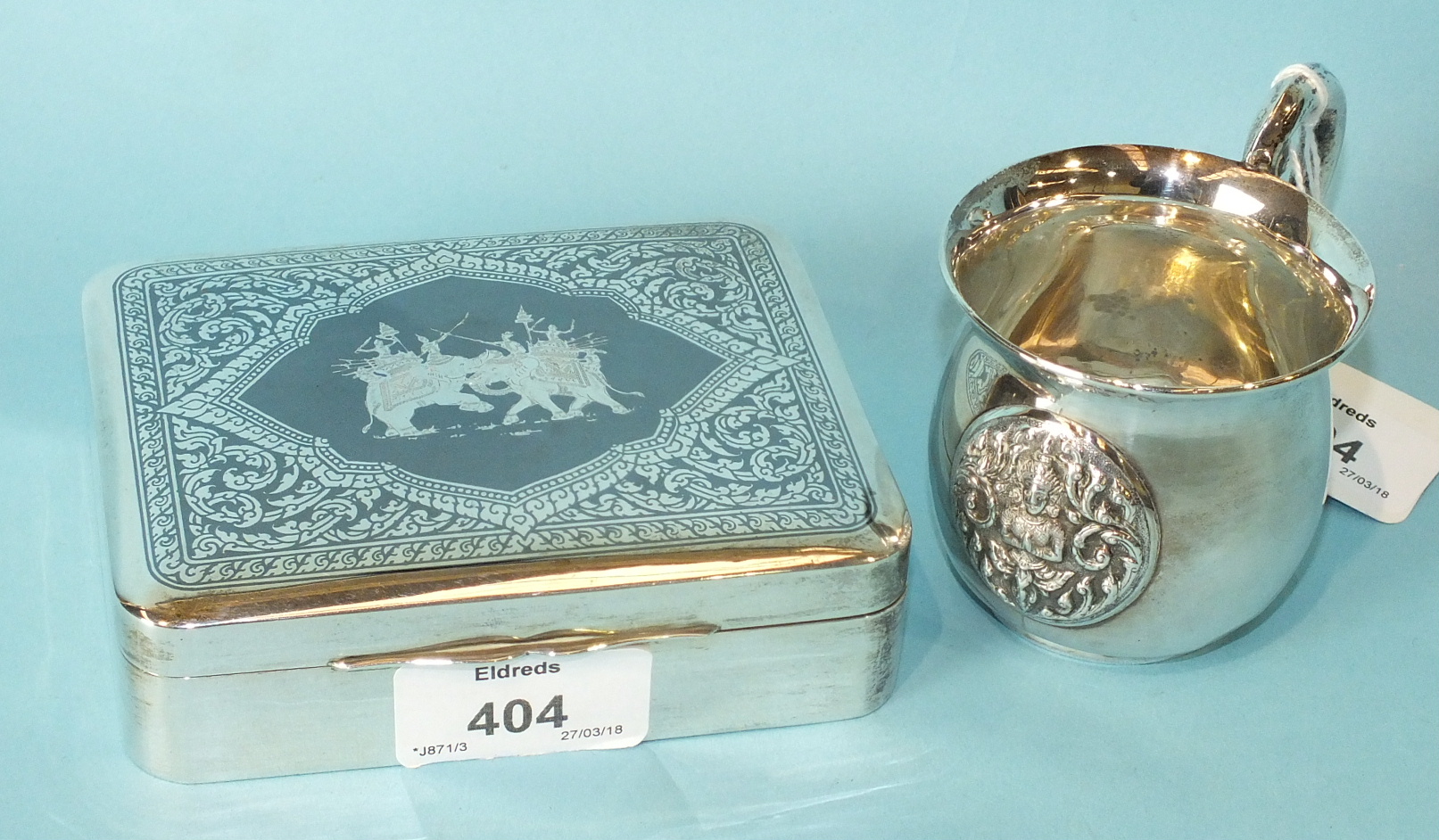 A Burmese rectangular niello-work sterling silver cigarette box with burr wood interior.